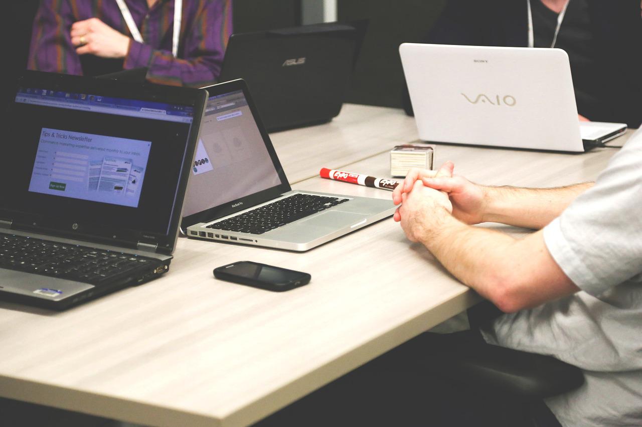 laptops desk mans arms work phone office